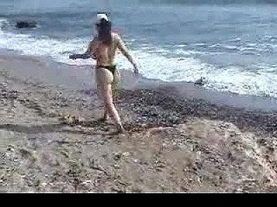 Girl at the beach showing big tits